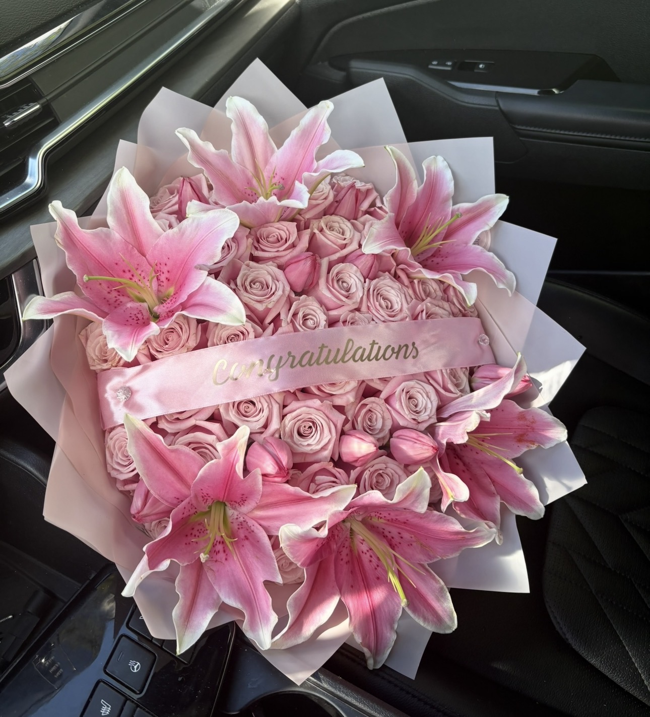Pink rose and lily bouquet with congratulations banner