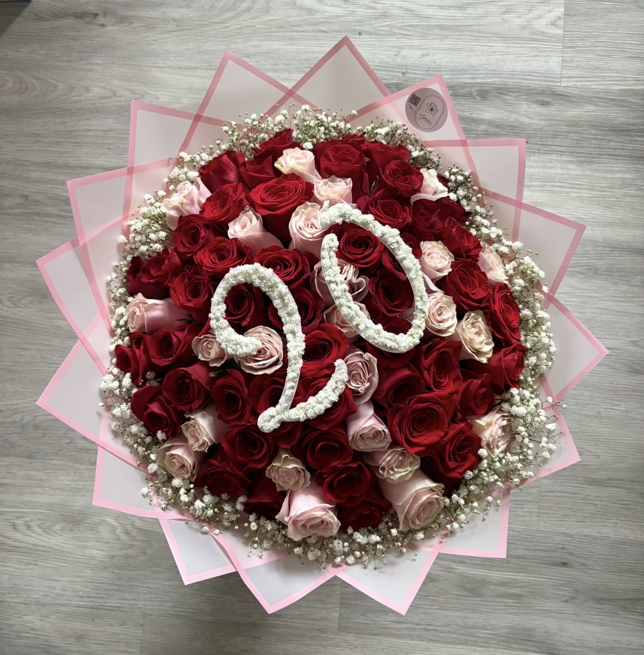 Red and blush rose bouquet with baby's breath letter